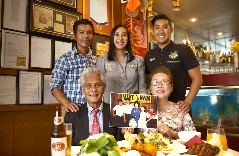 The Phan family in the Adelaide Vietnam restaurant with food on the table
